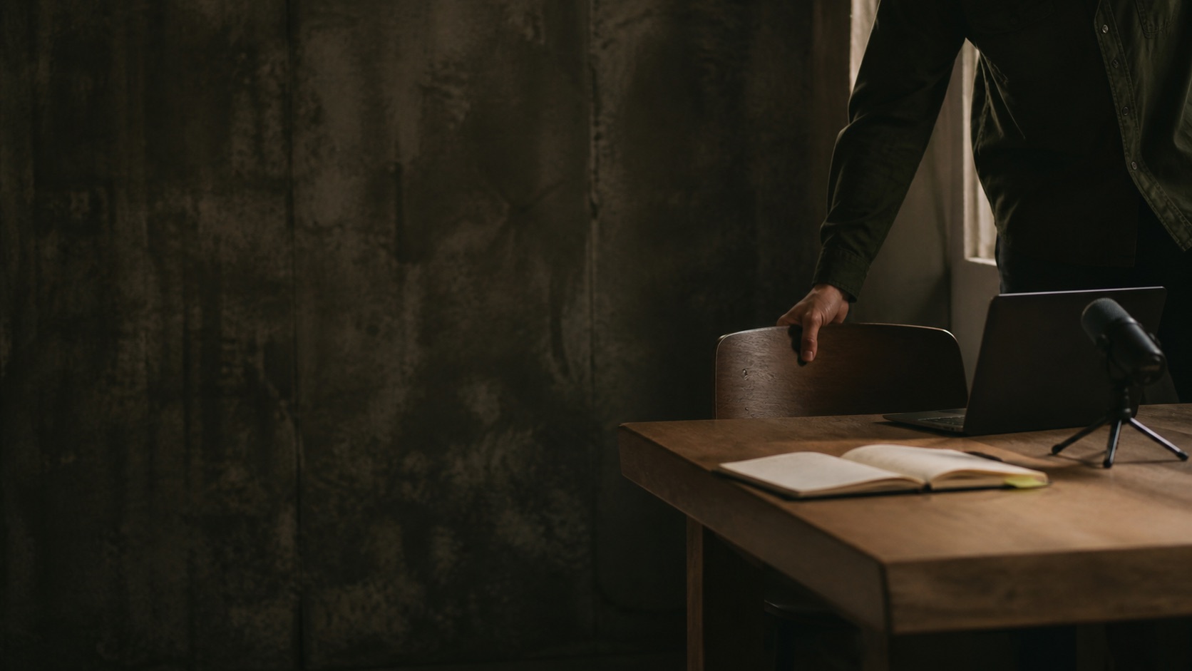 A chair being pulled toward a quiet studio desk